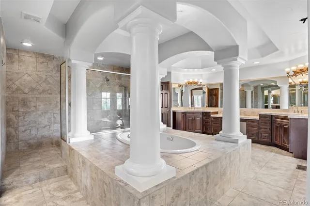 a large white kitchen with a large window and stainless steel appliances