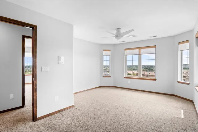 an empty room with windows and entrance