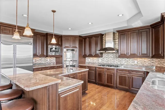 a kitchen with stainless steel appliances granite countertop stove top oven a sink and dishwasher