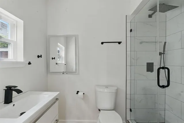 a bathroom with a sink toilet and shower
