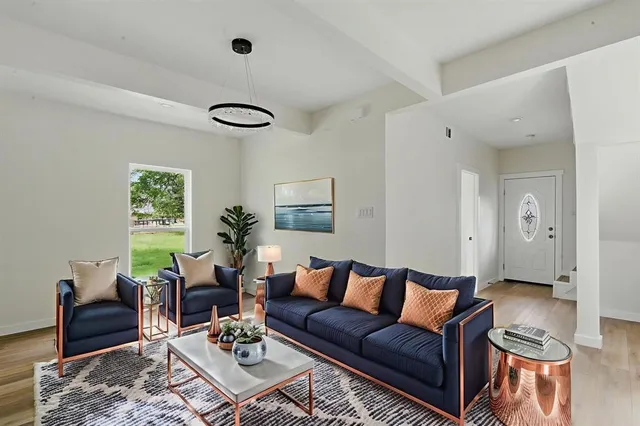a living room with furniture rug and window