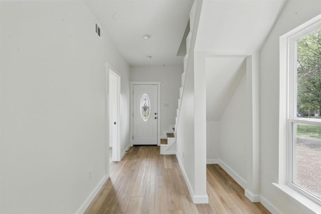 903 North Miller Street Decatur, TX 76234 - Photo 5 of 15 a view of a hallway with wooden floor and a bathroom