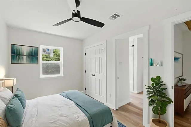 a bedroom with a bed and a potted plant