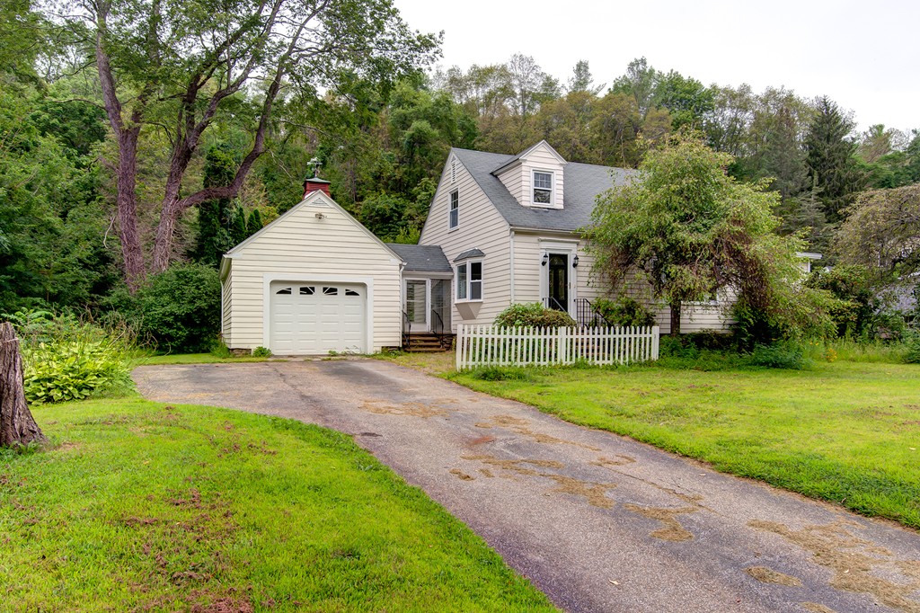 112 Wallace Road Sturbridge, MA 01566 - Photo 1 of 30 a front view of a house with a yard and trees