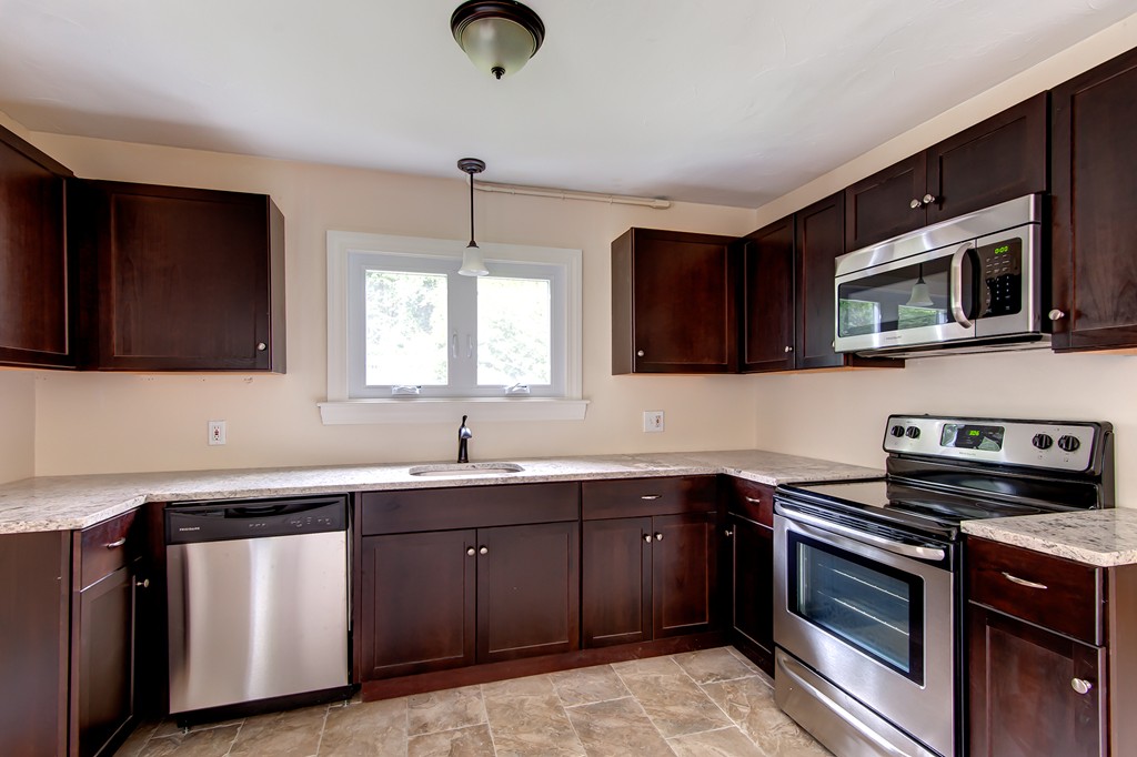 112 Wallace Road Sturbridge, MA 01566 - Photo 16 of 30 a kitchen with a sink stove and microwave