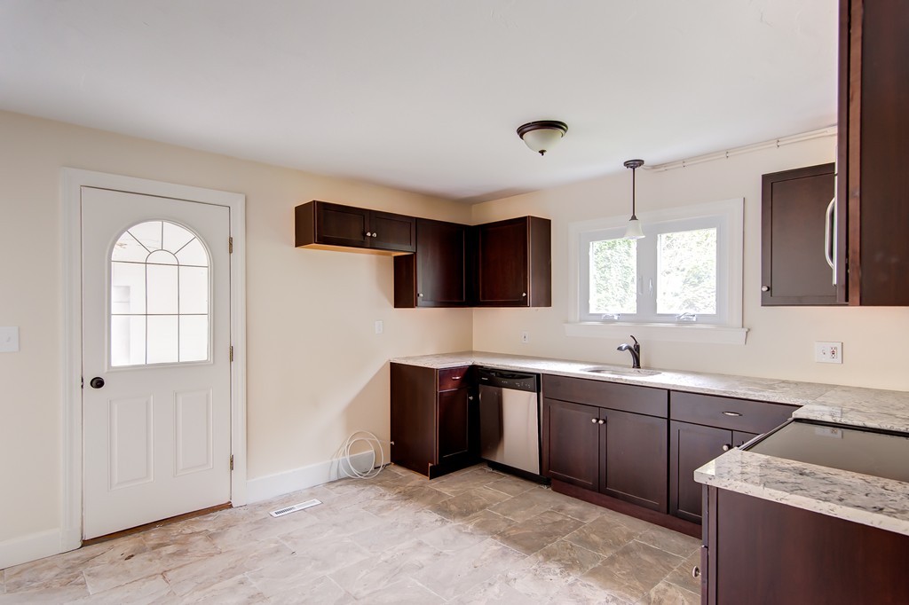 112 Wallace Road Sturbridge, MA 01566 - Photo 17 of 30 a view of a kitchen with stainless steel appliances granite countertop a sink and a stove top oven