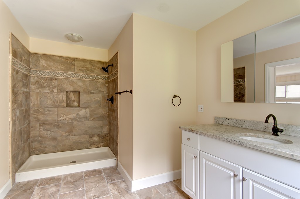 112 Wallace Road Sturbridge, MA 01566 - Photo 23 of 30 a bathroom with a shower sink and mirror