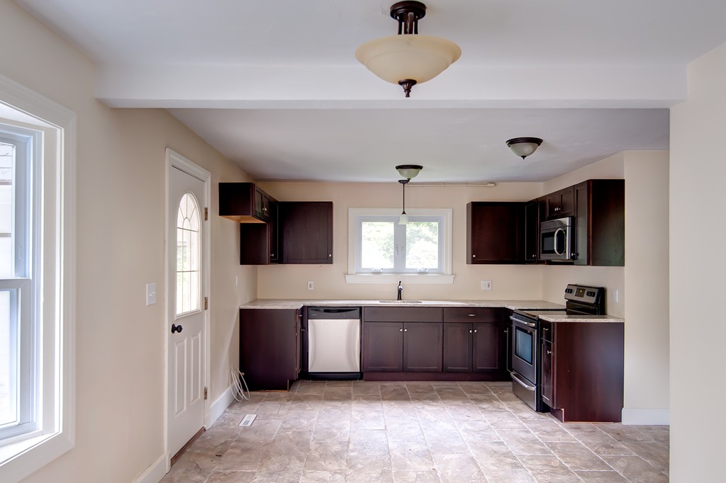 112 Wallace Road Sturbridge, MA 01566 - Photo 30 of 30 a kitchen with stainless steel appliances granite countertop a sink and dishwasher a stove top oven with wooden floor