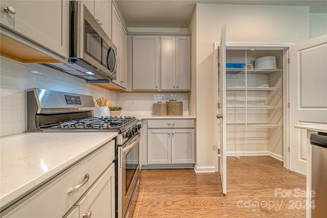 6048 Chelsea Oaks Ridge, Unit 2067 Tega Cay, SC 29708 - Photo 5 of 12 a kitchen with a stove and a refrigerator