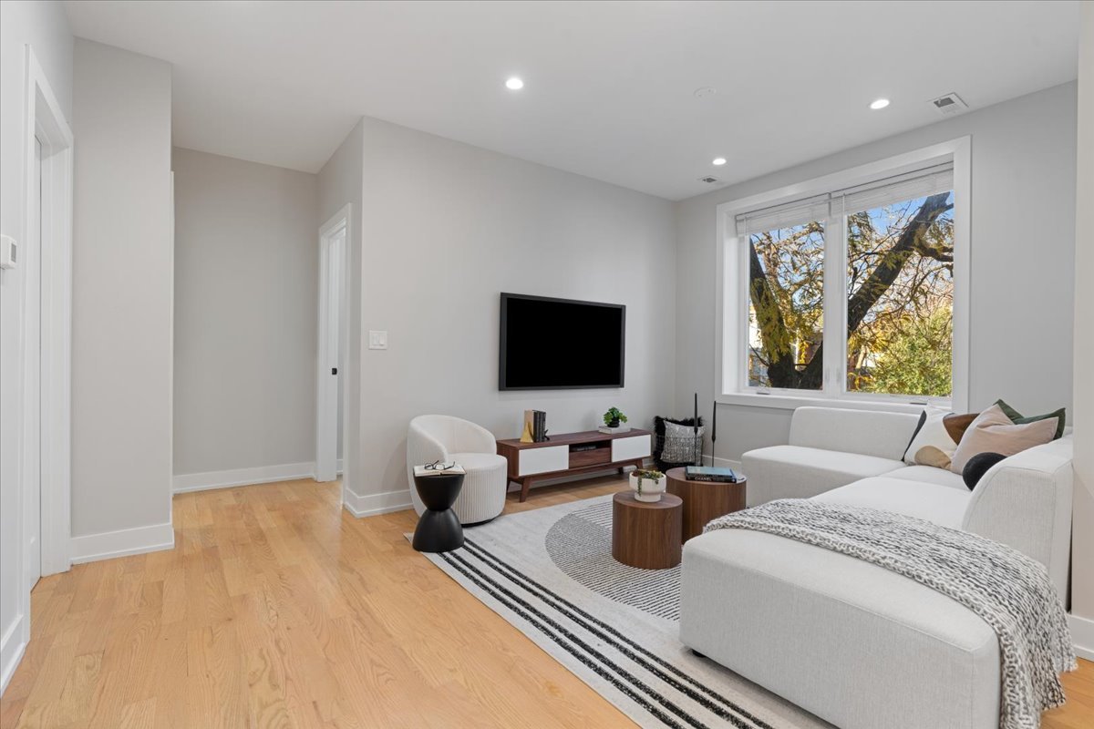 3653 West Barry Avenue, Unit 2W Chicago, IL 60618 - Photo 11 of 27 a living room with furniture and a flat screen tv