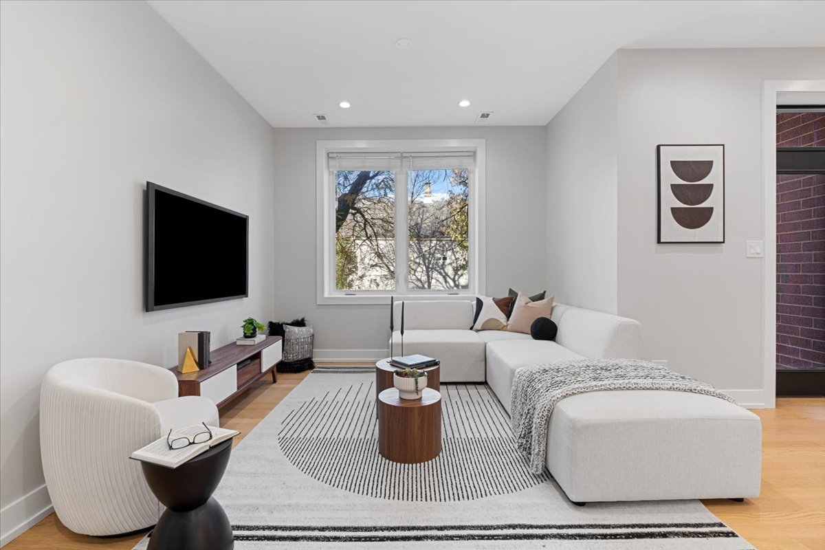 3653 West Barry Avenue, Unit 2W Chicago, IL 60618 - Photo 12 of 27 a living room with furniture and a flat screen tv