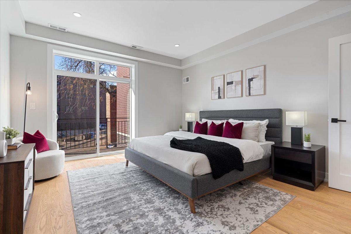 3653 West Barry Avenue, Unit 2W Chicago, IL 60618 - Photo 16 of 27 a spacious bedroom with a bed and a couch