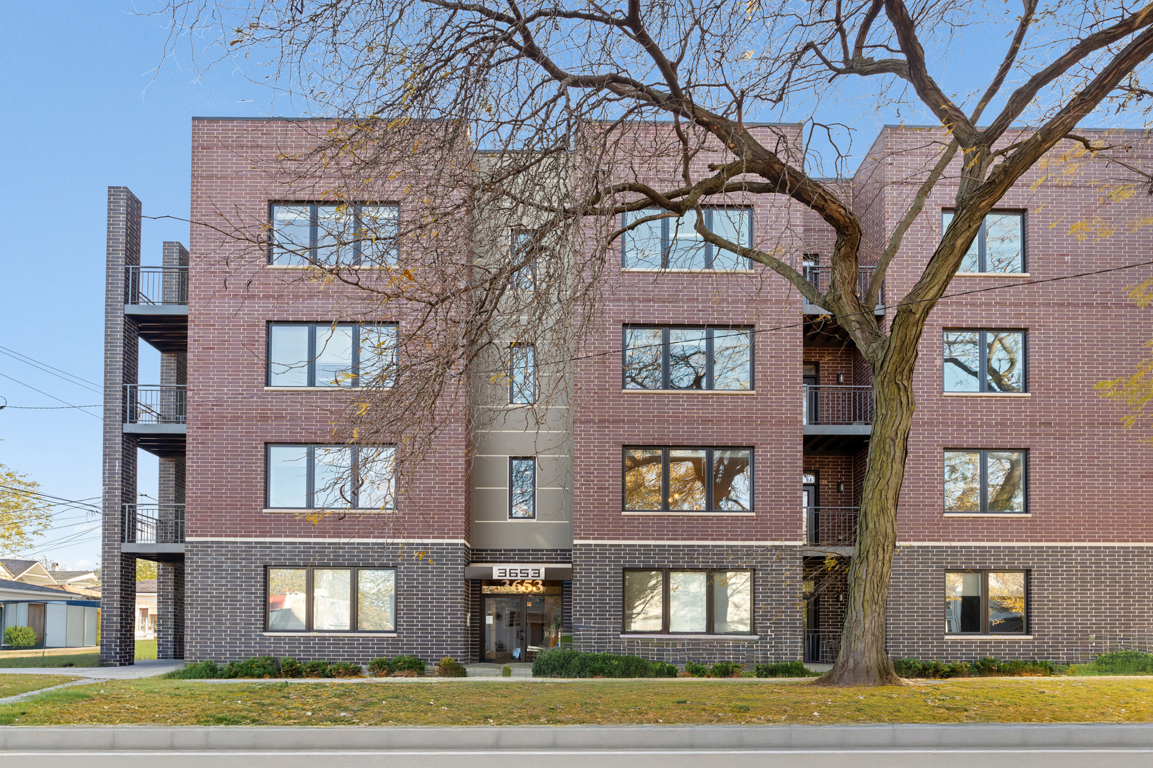 3653 West Barry Avenue, Unit 2W Chicago, IL 60618 - Photo 2 of 27 a front view of a multi story residential apartment building