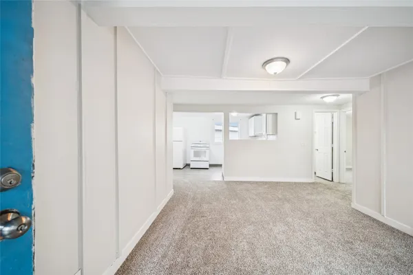 a kitchen with white cabinets and white appliances