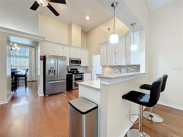 a kitchen with stainless steel appliances kitchen island a refrigerator and a stove