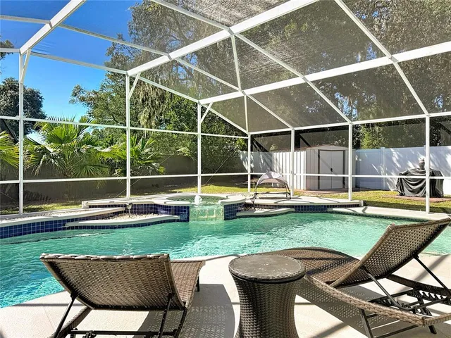 a spacious bedroom with a bed and a chandelier