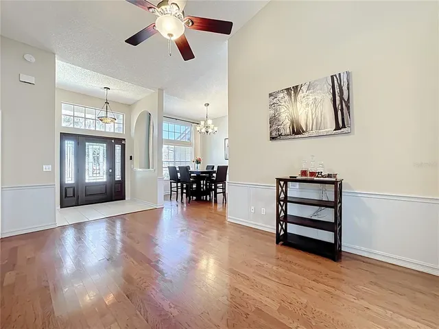 a view of a livingroom with furniture and a ceiling fan