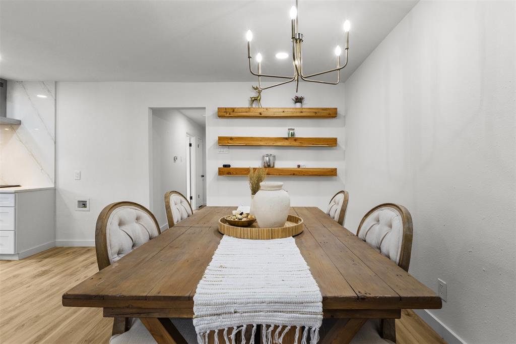 1917 South Vernon Avenue Dallas, TX 75224 - Photo 14 of 28 Dining area featuring wood-finish flooring and a contemporary chandelier