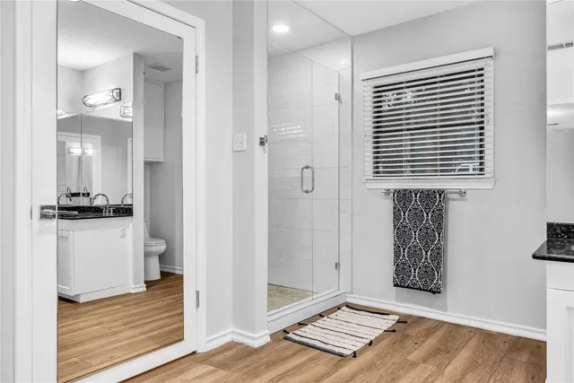 a view of an empty room and wooden floor