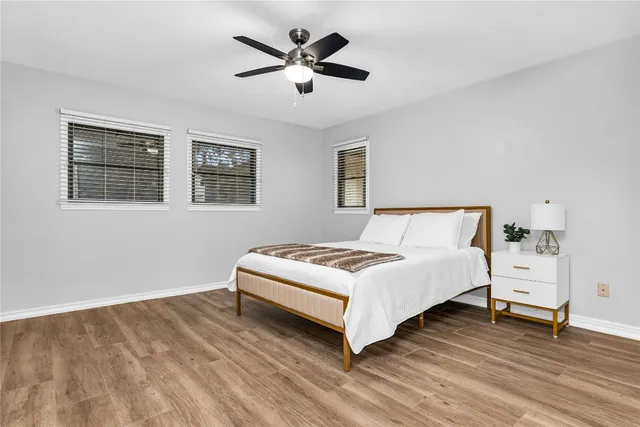 a bedroom with a bed and a ceiling fan