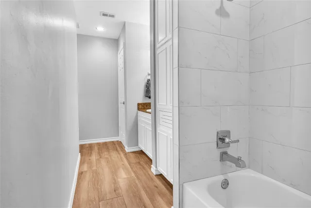 a bathroom with a bathtub and shower