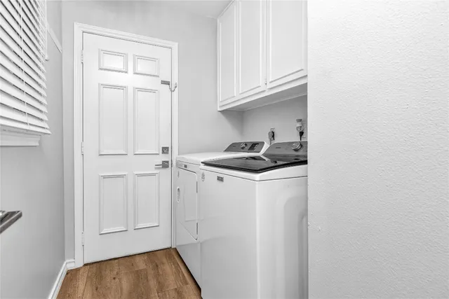 a kitchen with white cabinets and sink