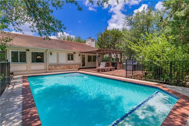 a view of a house with swimming pool and porch with furniture