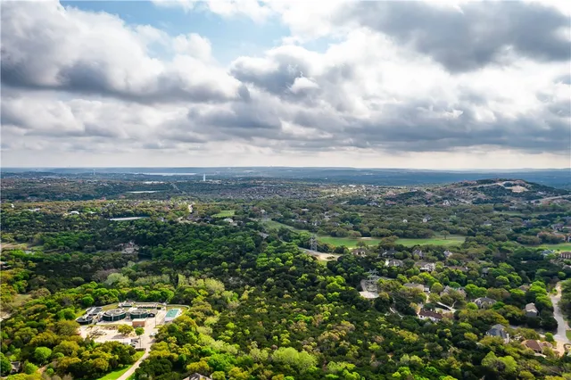 a view of a city with lush green forest