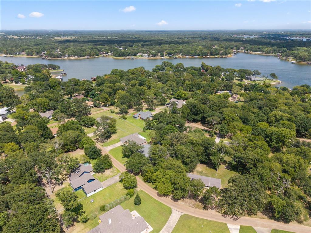 116 Meadowood Road Enchanted Oaks, TX 75156 - Photo 31 of 37 Expansive lakefront community featuring mature trees and a clear blue sky
