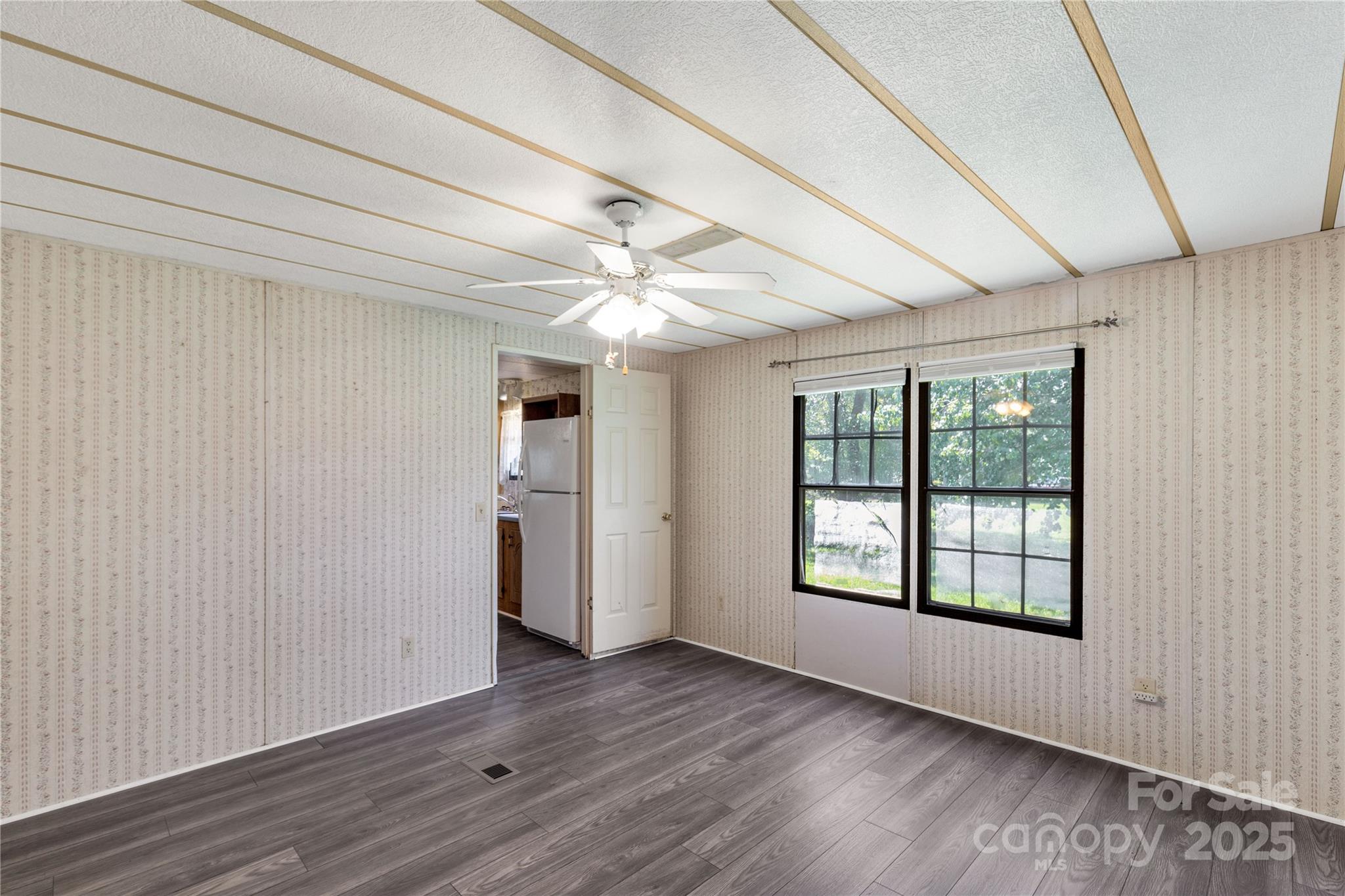 4331 Palmer Lloyd Road, Unit 11 Lancaster, SC 29720 - Photo 11 of 36 a view of an empty room with wooden floor and a window