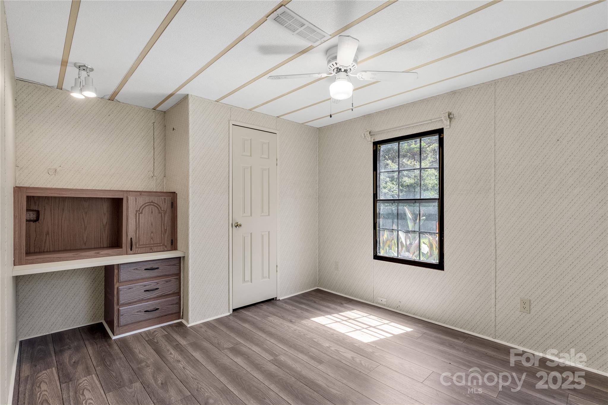 4331 Palmer Lloyd Road, Unit 11 Lancaster, SC 29720 - Photo 16 of 36 a view of an empty room with a window and wooden floor