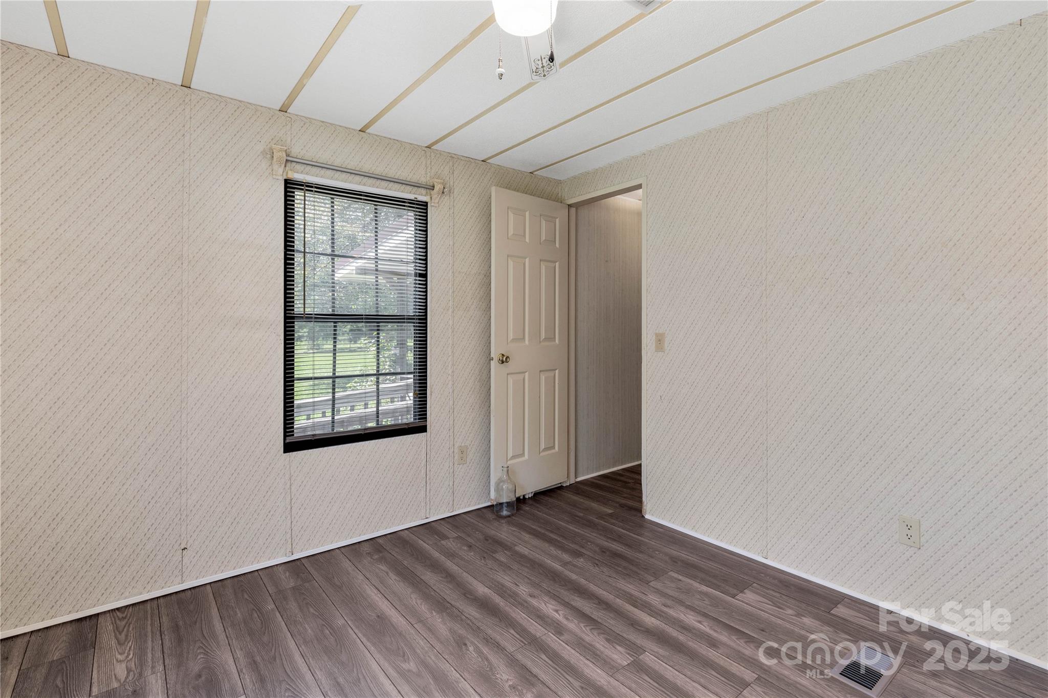 4331 Palmer Lloyd Road, Unit 11 Lancaster, SC 29720 - Photo 17 of 36 an empty room with wooden floor and windows