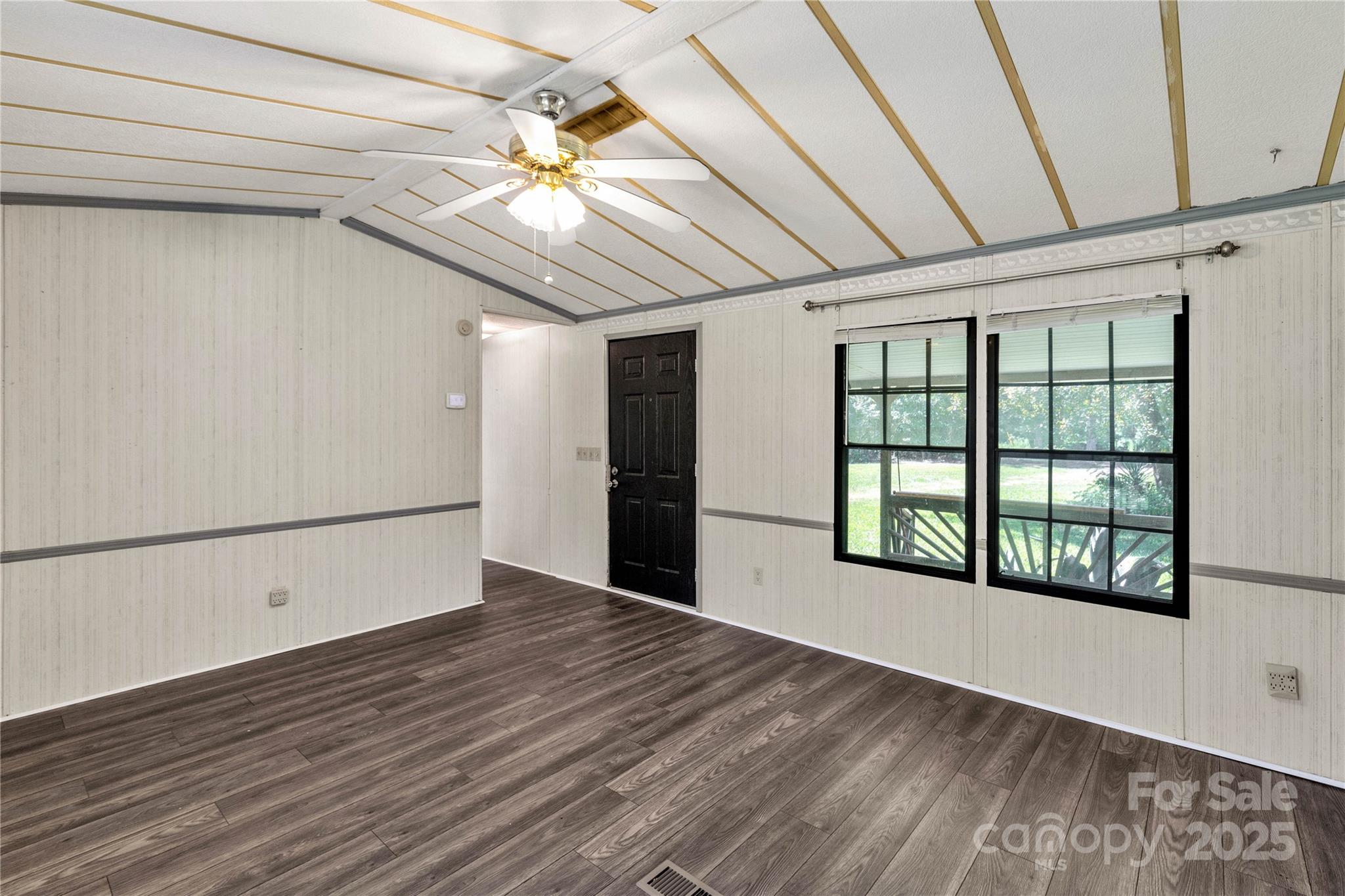 4331 Palmer Lloyd Road, Unit 11 Lancaster, SC 29720 - Photo 5 of 36 a view of an empty room with a window and wooden floor