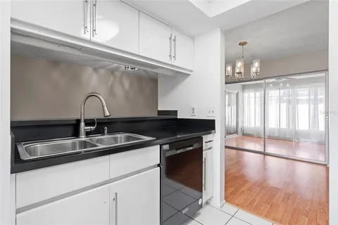 a close view of a sink a counter space and cabinets