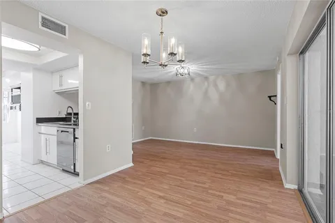 a view of a kitchen with a sink and a refrigerator