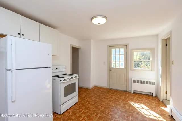 a kitchen with a white cabinets and white refrigerator