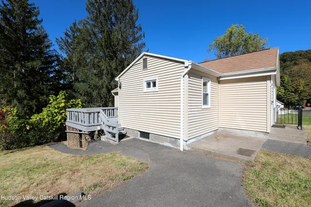 a view of a chair and table in the backyard