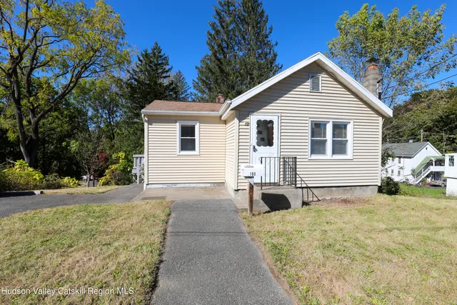 a view of a house with a yard and garage