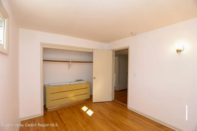 a view of room with wooden floor