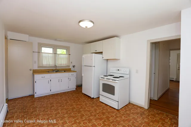 a kitchen with a stove a sink and a refrigerator