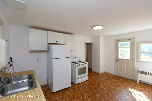 a kitchen with a refrigerator and a sink