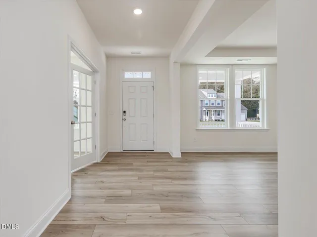 wooden floor in an empty room with a window