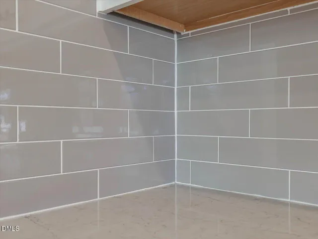a view of a hallway with wooden floor and entryway