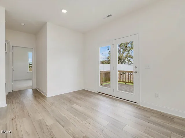 a view of an empty room with a fireplace