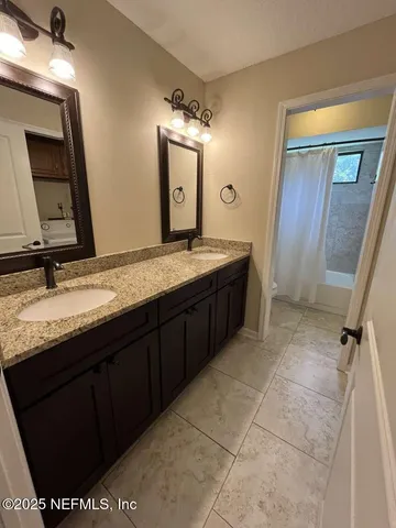 a bathroom with a granite countertop sink a mirror and a