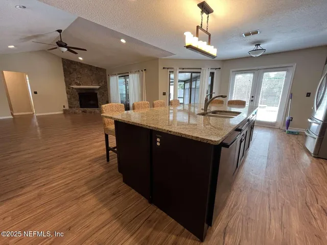 a kitchen with sink cabinets and wooden floor