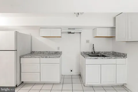 a kitchen with granite countertop cabinets and steel stainless steel appliances