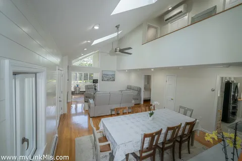 a dining room with furniture and wooden floor