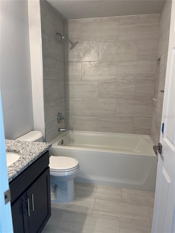 4519 East Walker Street Inverness, FL 34453 - Photo 5 of 8 a bathroom with a granite countertop sink a toilet and bathtub