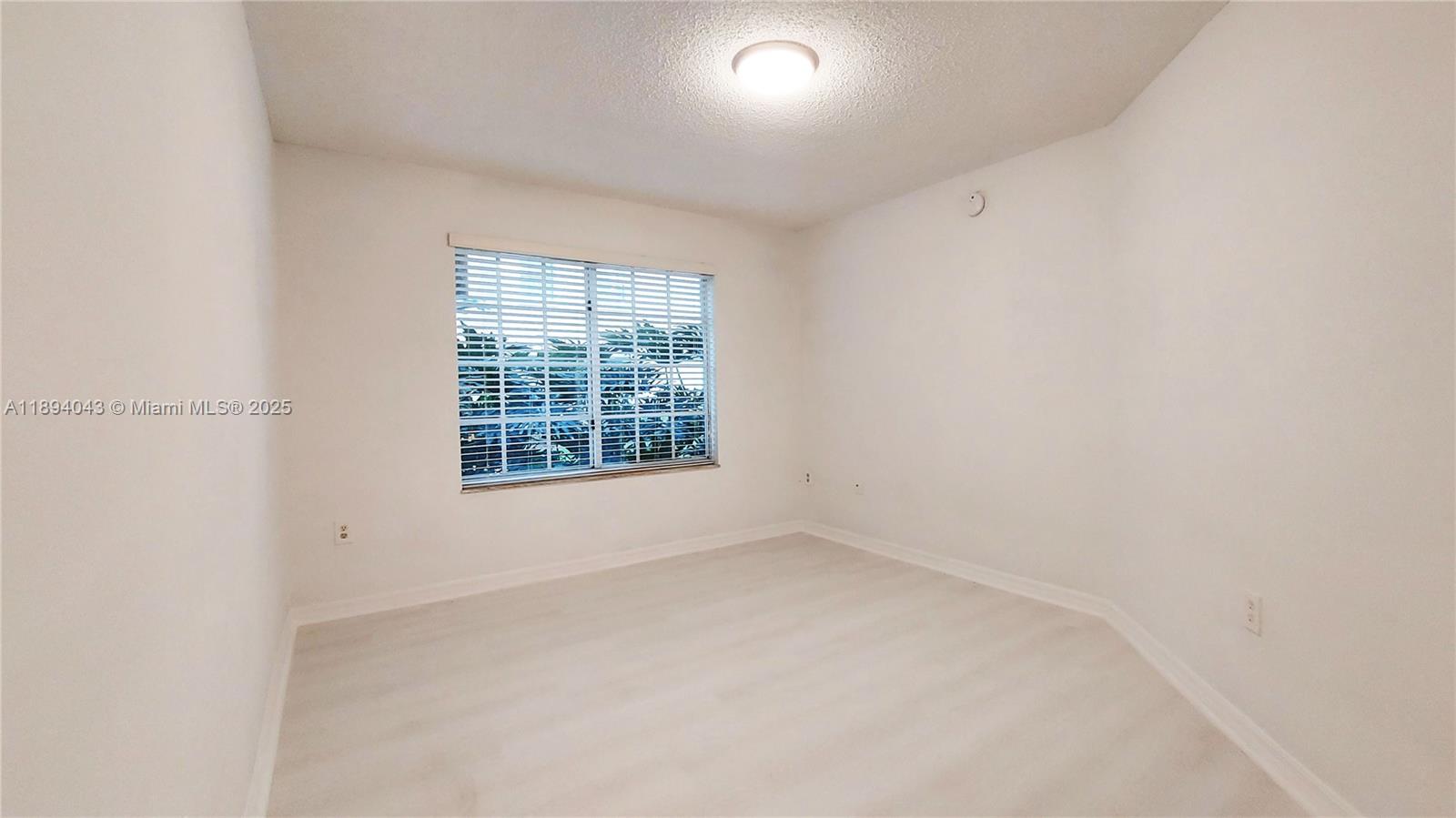 2457 Centergate Drive, Unit 108 Miramar, FL 33025 - Photo 12 of 18 an empty room with a window